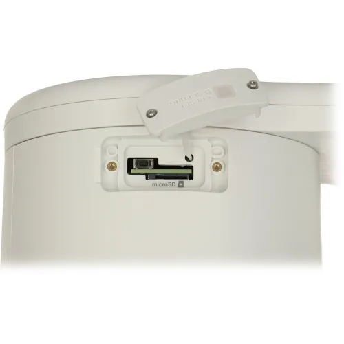 Zdjęcie przedstawia białe urządzenie z otwartym gniazdem na kartę microSD oraz przyciskiem reset. Gniazdo znajduje się na bocznej części urządzenia, a obok widoczny jest uchylony plastikowy panel z napisem "RESET SETTING".