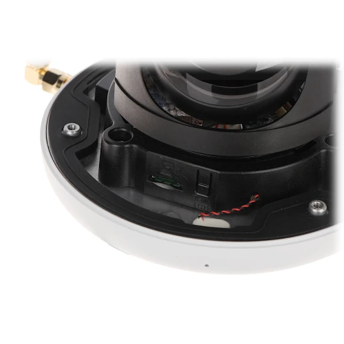 Zdjęcie przedstawia gniazdo karty pamięci oraz przycisk reset umieszczone wewnątrz obudowy urządzenia elektronicznego. Elementy te są zamontowane na czarnej plastikowej podstawie, otoczone metalowymi śrubami.