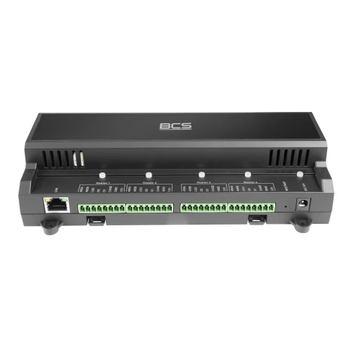 Na zdjęciu znajduje się czarny kontroler dostępu BCS z widocznymi portami i złączami na przednim panelu. Urządzenie ma kompaktowy, prostokątny kształt z logo BCS na górze.
