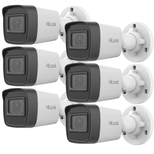 Na zdjęciu znajduje się zestaw sześciu białych kamer monitoringu marki HiLook, zamontowanych na białych uchwytach ściennych. Kamery są ułożone w dwóch rzędach po trzy sztuki, skierowane w lewą stronę.