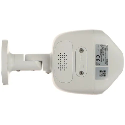 Zdjęcie przedstawia biały, montowany na ścianie aparat monitorujący widziany od spodu, z widocznymi śrubami montażowymi i etykietami z informacjami technicznymi. Urządzenie ma prostokątną obudowę z otworami wentylacyjnymi i przyciskiem resetowania.