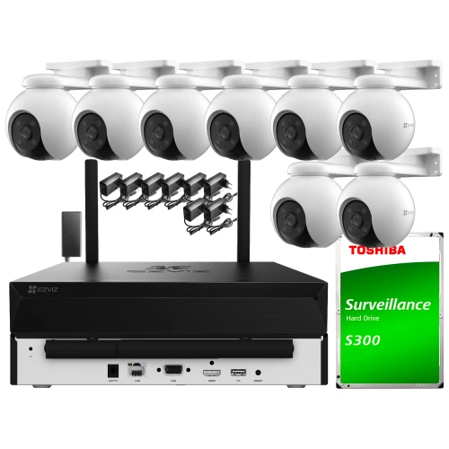 Zestaw do monitoringu składa się z ośmiu białych kamer Wi-Fi, rejestratora oraz dysku twardego Toshiba S300. Kamery są rozmieszczone w dwóch rzędach, a poniżej znajduje się rejestrator z różnymi portami i przyciskami.